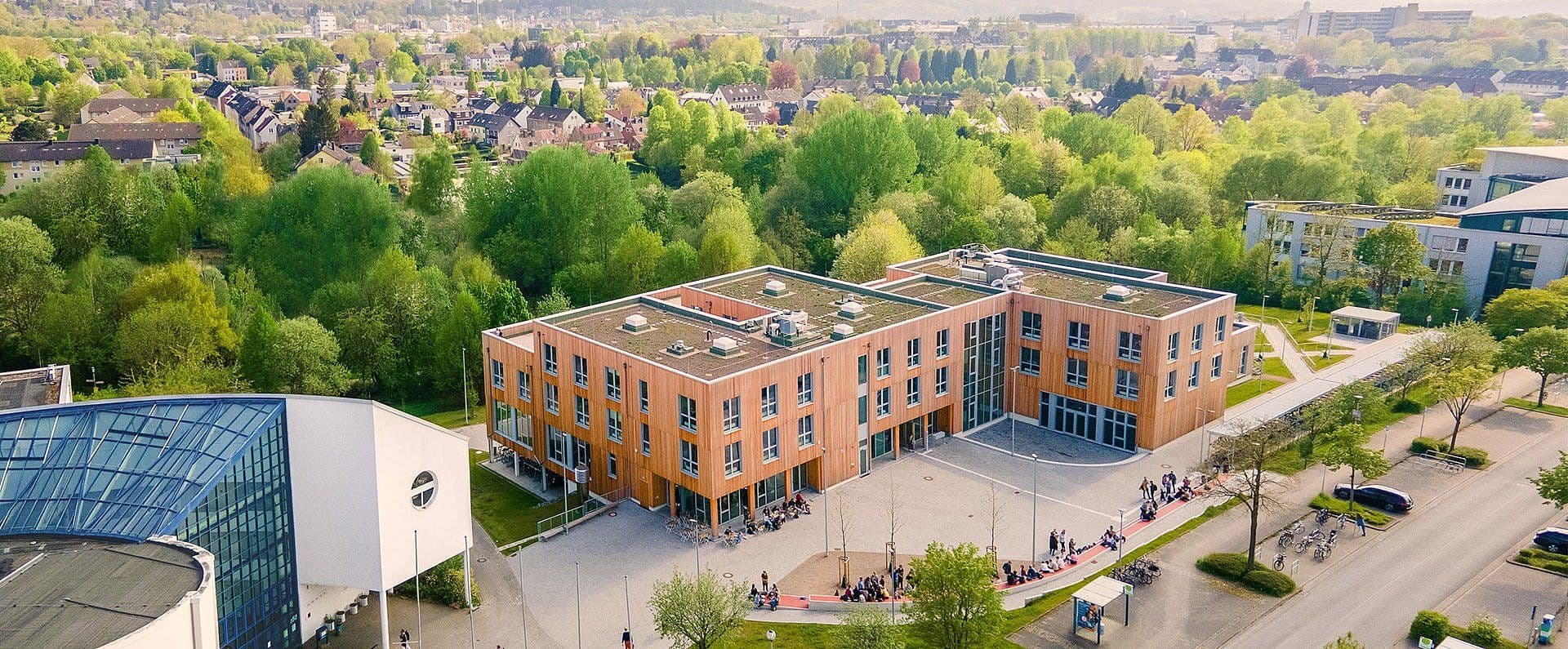 University of Witten/Herdecke campus view, showing modern academic buildings and student facilities, reflecting a focus on health sciences and interdisciplinary learning.