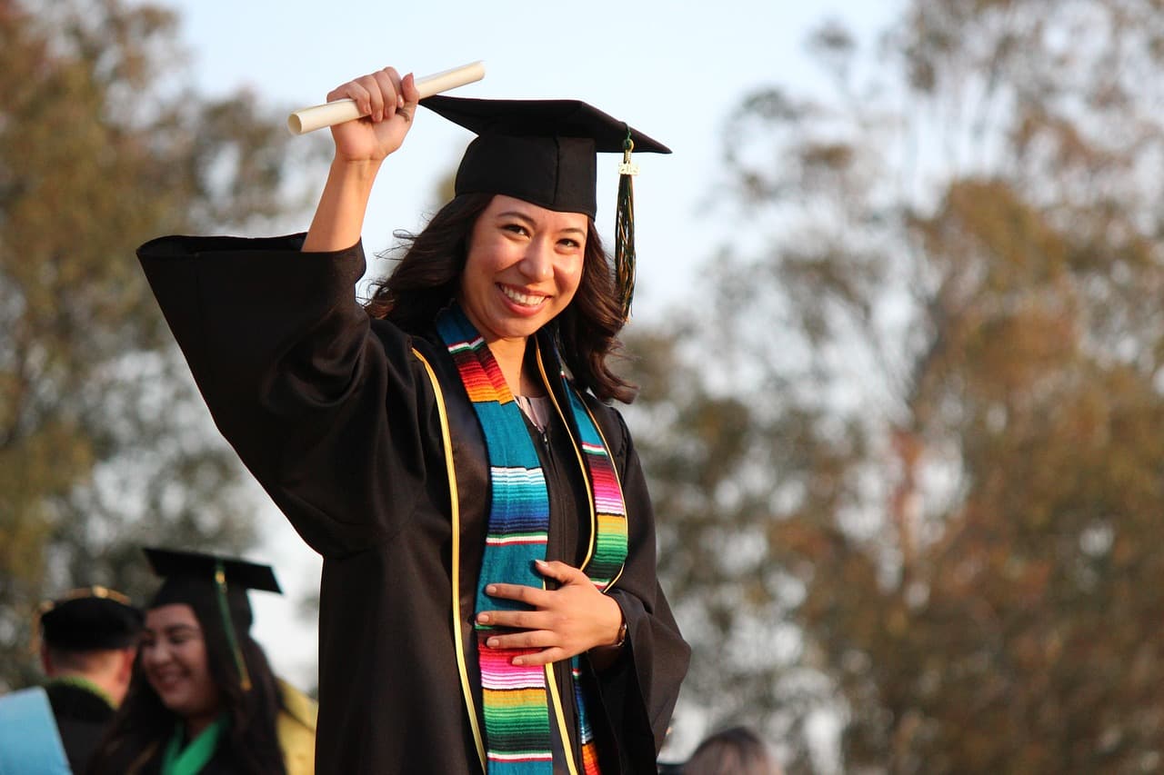 Graduates in caps and gowns at a university graduation ceremony