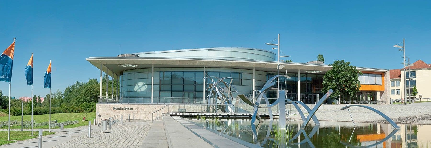 Main building of Ilmenau University of Technology, featuring modern architecture and campus green spaces in Ilmenau, Germany.