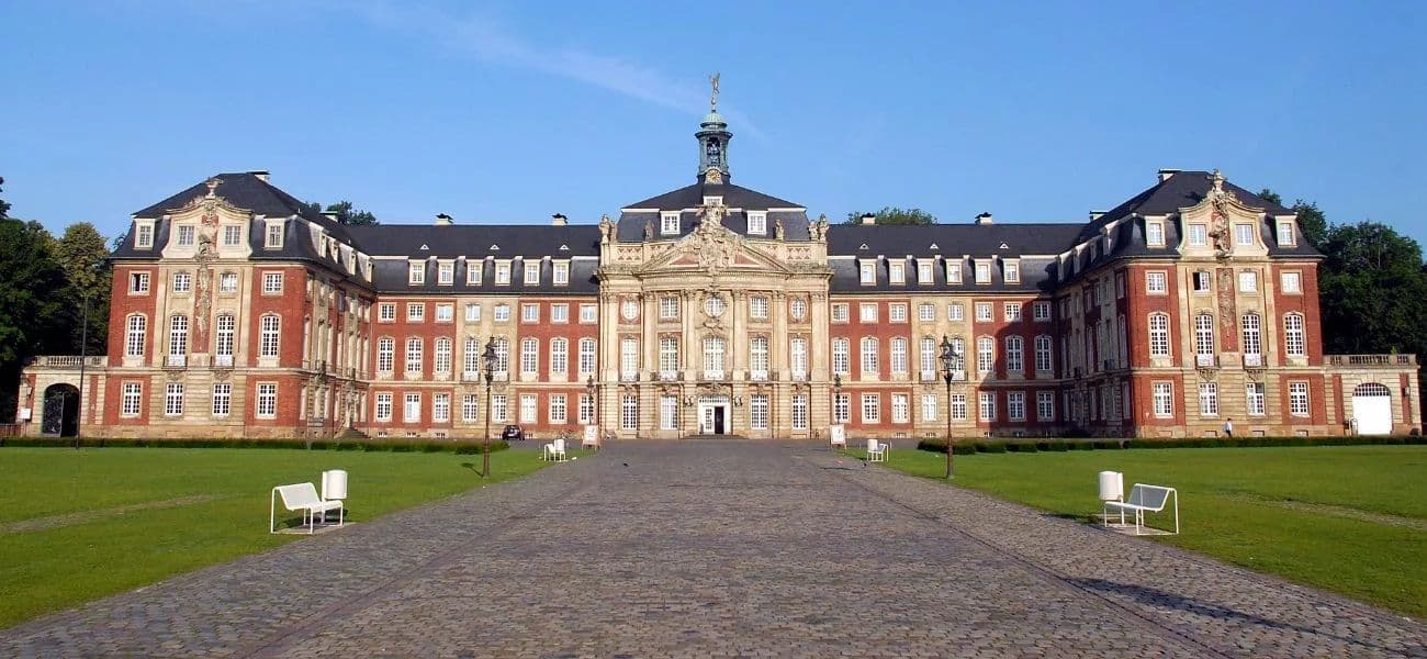 Campus view of University of Münster showing modern academic buildings, green spaces, and student facilities.
